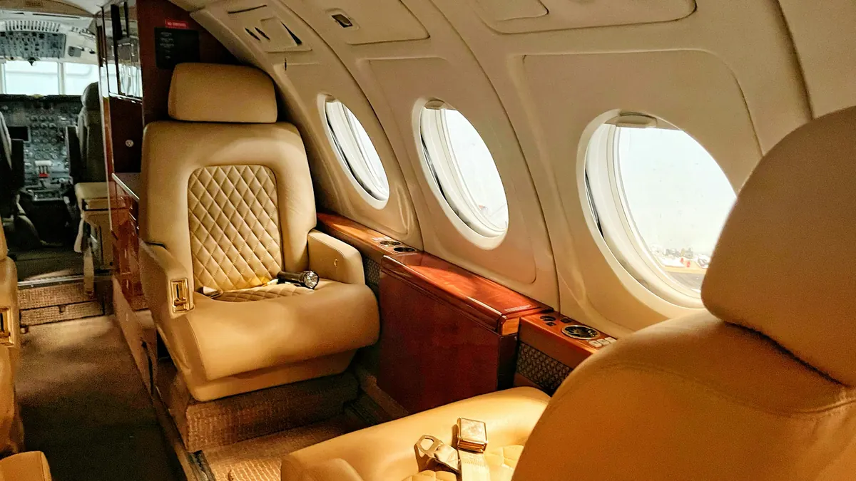 Quilted leather seats in a warmly lit private jet cabin